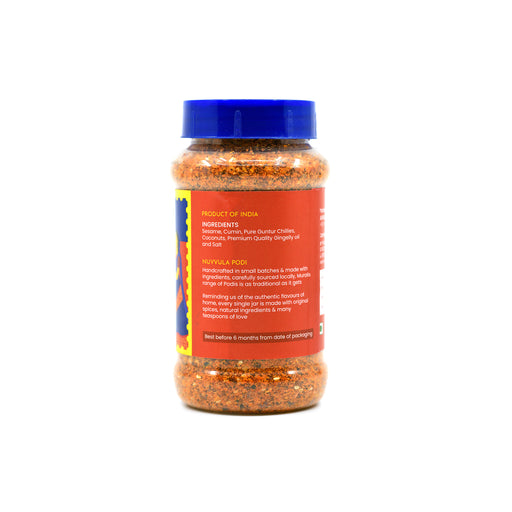 A plastic bottle of Nuvvula Red Chili Seasoning with a blue cap and a red label, shown on a plain white background. Muralis Nuvvula Podi ingredients and product information
