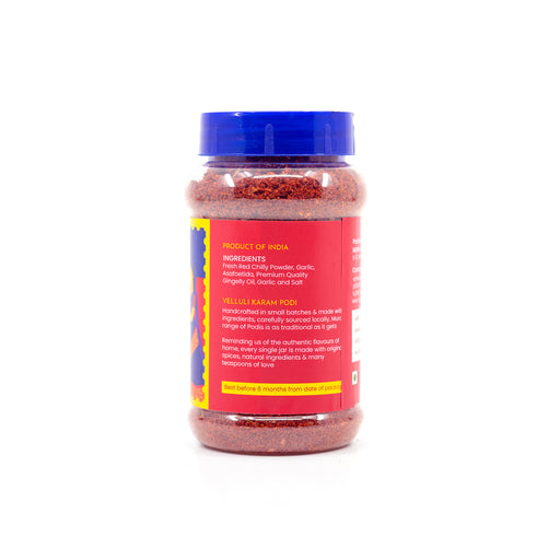 A clear plastic jar of Indian Red Chili Powder with a blue screw cap and a red label, shown on a plain white background. Muralis Velluli Karam ingredients and product information