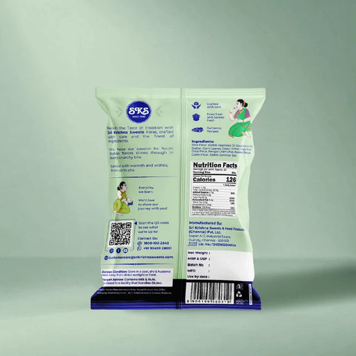 Back of a 6X6 branded snack bag standing upright on a matching blue and purple branded base, photographed against a pale mint green studio background.