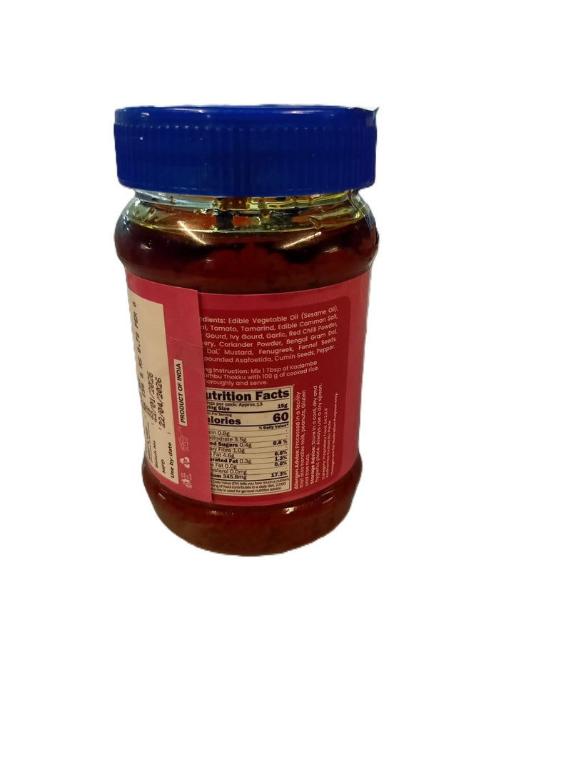 Jar of honey with a blue lid on a white background