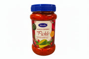 Jar of Muralis Mango Thokku Pickle with blue lid on a white background
