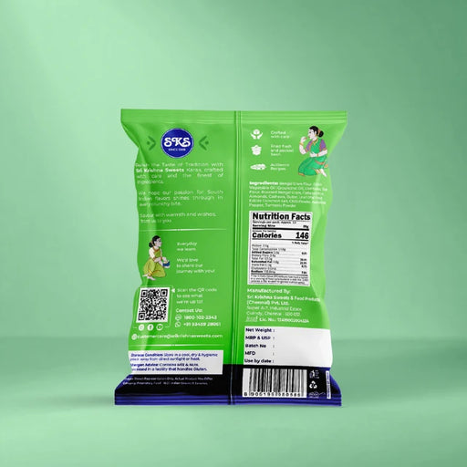 The back of a green 69% salted potato chips bag standing upright on a dark blue wrapper, set against a solid mint green background.