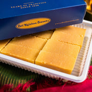 Box of Sri Krishna Sweets with yellow squares on a green and red background