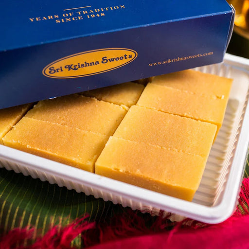 Box of Sri Krishna Sweets with yellow squares on a green and red background
