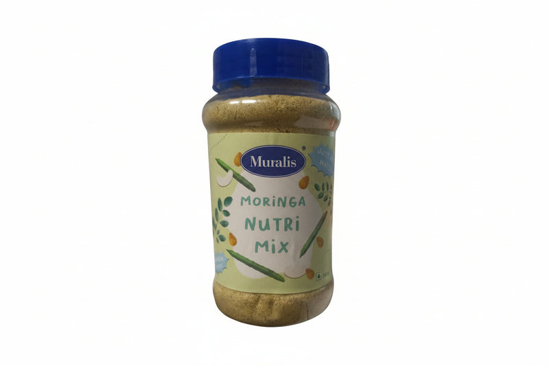 A plastic jar labeled 'Moringa Nutri Mix' by Muralis, with a blue lid and a label showing an illustration of moringa leaves and fruits.