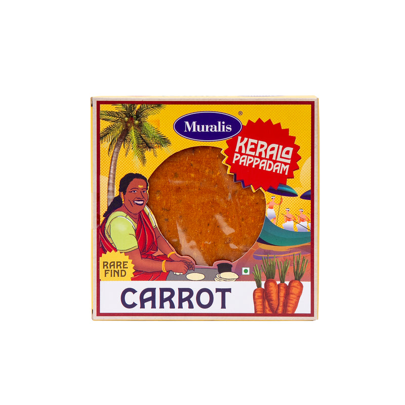 Carrot Pappadam box with orange pappadam visible through the front window and traditional Kerala artwork